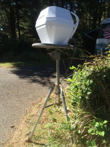 An old manual aim dish balancing a new auto-aiming dish: Some RVers go to extremes to get a clear shot of the southern sky.