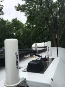 Antennas are sprouting on our roof like barnacles. From left to right: BoatAnt-1, MobileMark 4-in-1, weBoost MiniMag, Max-Amp Antenna, weBoost MiniMag #2, BoatAnt-2 MIMO, and weBoost Trucker 4G.