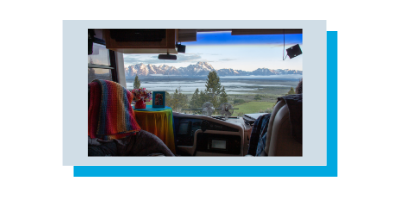 Photo taken through Class A RV dash window with a MIMO antenna mounted showing the Teton Mountains