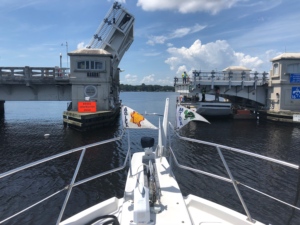 A boat about to go under a drawbridge